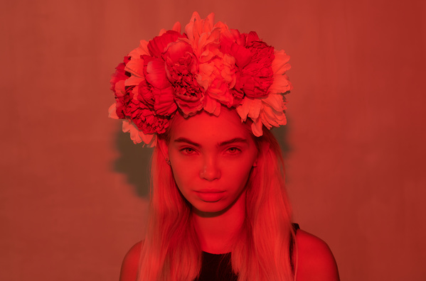 Woman with Wreath of Peonies on Her Head by Red Lighting